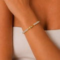Front detail of Elara gold cuff bracelet with twisted center design and zircon stones