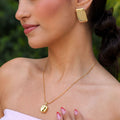 Elara gold organic pendant necklace worn by model