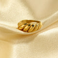 gold ring on fabric soft luxury styling