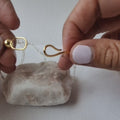 Close-up video of Aurelia necklace showing its sculptural front clasp and mixed metal design
