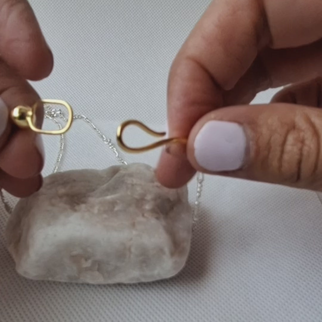 Close-up video of Aurelia necklace showing its sculptural front clasp and mixed metal design