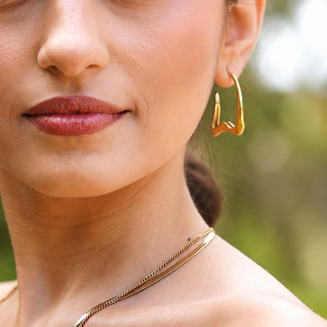 Vela gold stainless steel sculptural earrings with open geometric design